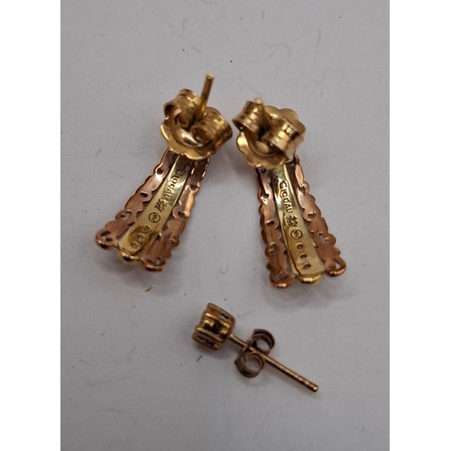 53 - A pair of Clogau 9ct gold and rose gold earrings with 3 inset white stones to each earring having 9c... 