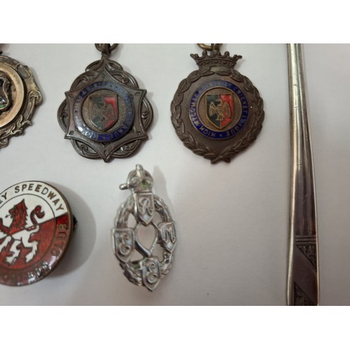 58 - A quantity of cap badges, vintage badges and medals to include mid 20th Century silver football meda... 