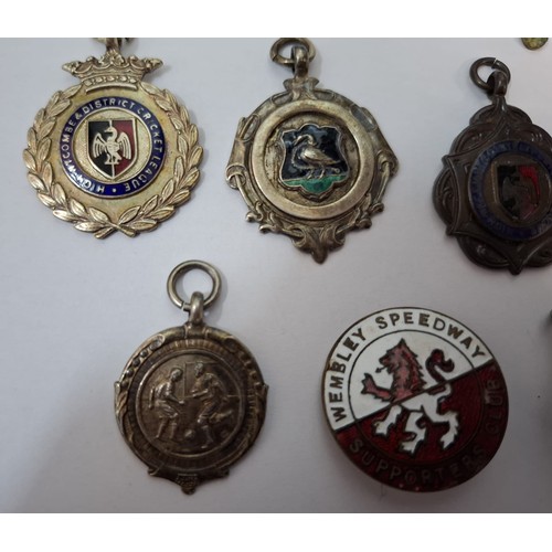 58 - A quantity of cap badges, vintage badges and medals to include mid 20th Century silver football meda... 