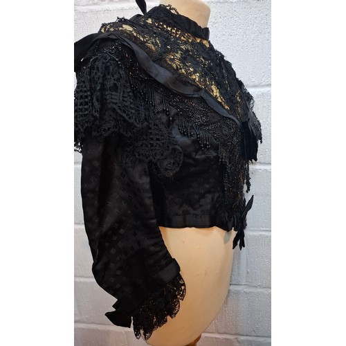 48 - ***THIS LOT HAS BEEN WITHDRAWN*
A Victorian ladies mourning blouse A/F decorated with black lace, ri... 