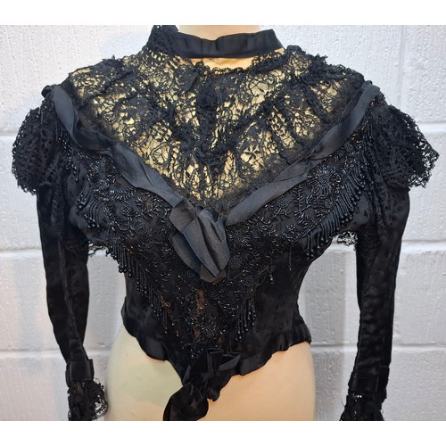 48 - ***THIS LOT HAS BEEN WITHDRAWN*
A Victorian ladies mourning blouse A/F decorated with black lace, ri... 