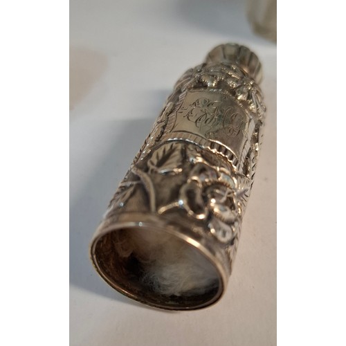 25 - Four silver dressing table items comprising 2 glass pots with silver lids, a circa 1900 silver embos... 