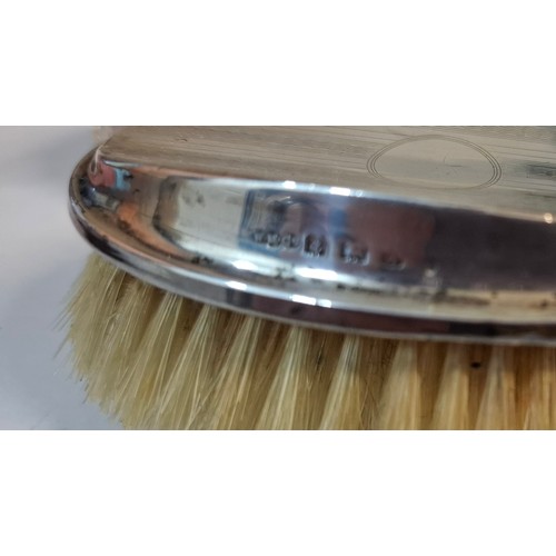 25 - Four silver dressing table items comprising 2 glass pots with silver lids, a circa 1900 silver embos... 