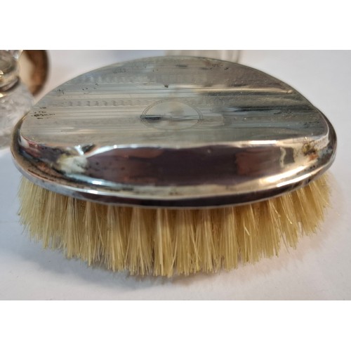25 - Four silver dressing table items comprising 2 glass pots with silver lids, a circa 1900 silver embos... 