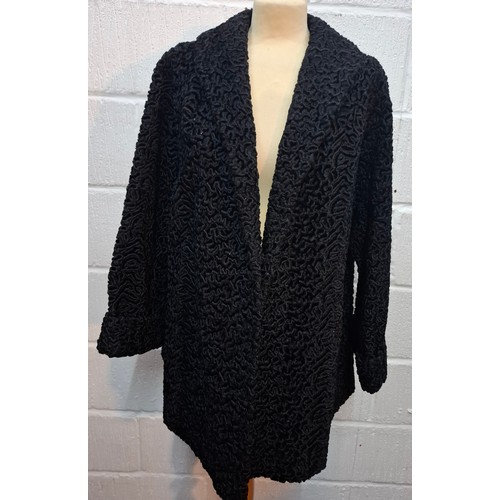 49 - A vintage black astrakhan swing coat, approx 40