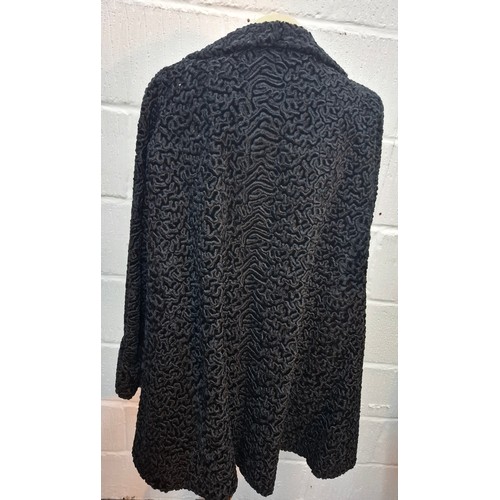 49 - A vintage black astrakhan swing coat, approx 40