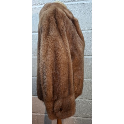 51 - A mid 20th Century mid brown mink jacket having 2 pockets, buttoned cuffs and olive green lining, ap... 