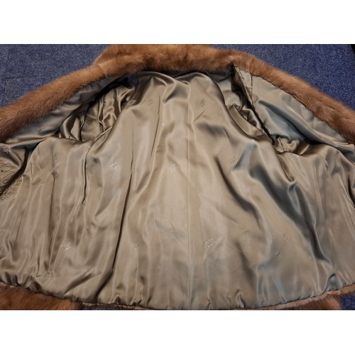 51 - A mid 20th Century mid brown mink jacket having 2 pockets, buttoned cuffs and olive green lining, ap... 