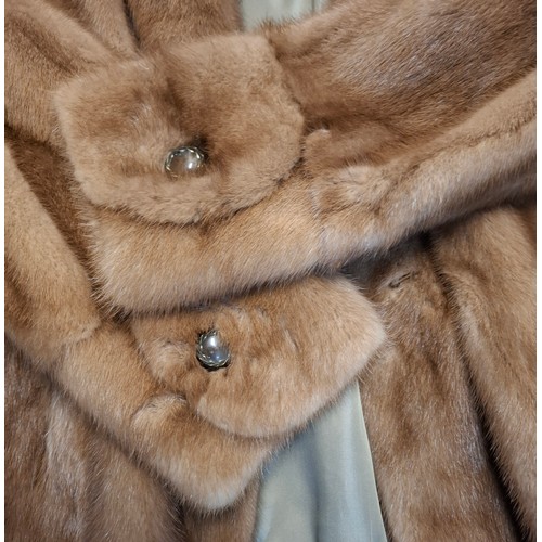 51 - A mid 20th Century mid brown mink jacket having 2 pockets, buttoned cuffs and olive green lining, ap... 
