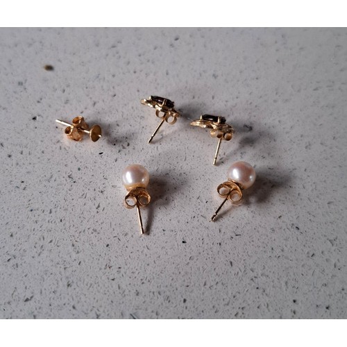 24 - A pair of yellow metal earrings having a red stone and 9ct gold earring backs, a pair of yellow meta... 