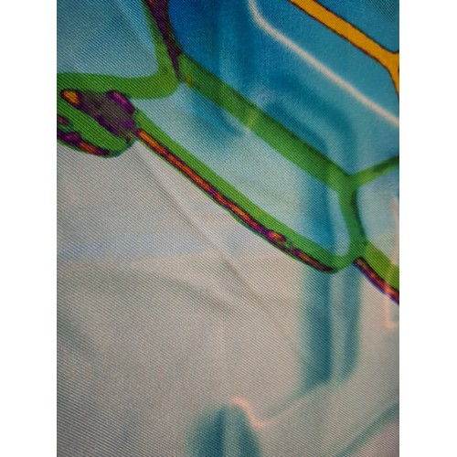 6 - Bulgari/Bvlgari- A silk scarf in tones of turquoise, purple, green and gold having the brand name in... 