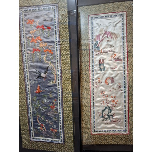 41 - Four framed Oriental embroidered silk panels to include a pair of Chinese blue silk panels depicting... 