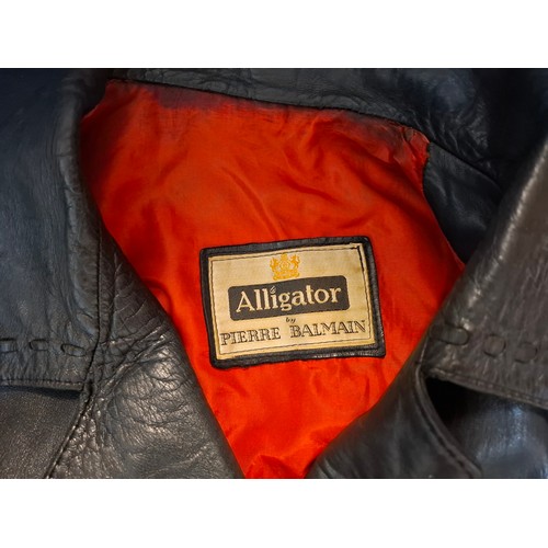 9 - Pierre Balmain-An early 1960's ladies black alligator coat having 2 front pockets and red lining, ap... 