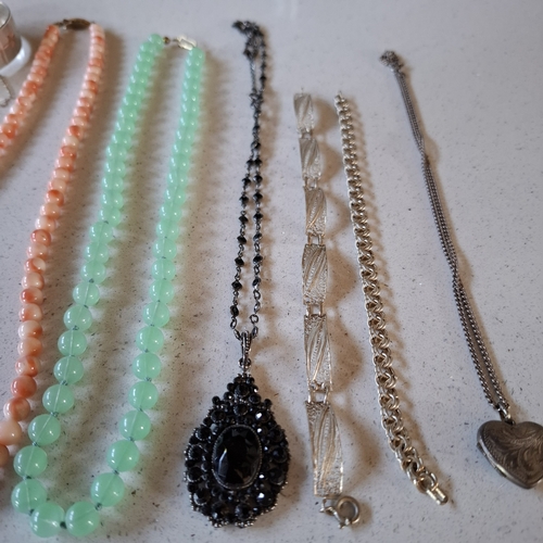 18 - A pearl necklace having a 9ct gold clasp stamped 375, 2 silver hinged bangles, a coral necklace with... 