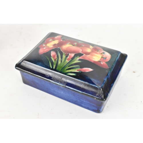 104 - A group of early/mid 20th century Moorcroft pottery to include a 'pomegranate' patter pewter mounted... 