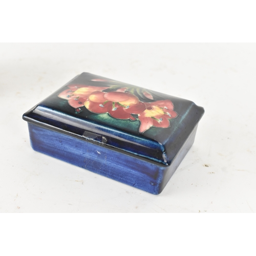 104 - A group of early/mid 20th century Moorcroft pottery to include a 'pomegranate' patter pewter mounted... 