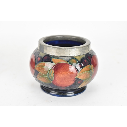 104 - A group of early/mid 20th century Moorcroft pottery to include a 'pomegranate' patter pewter mounted... 