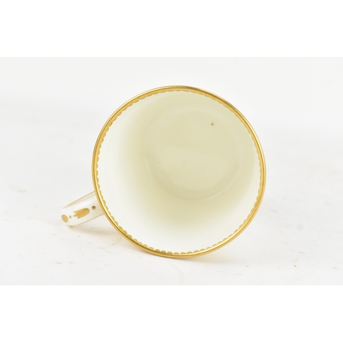 182 - A late 18th century Sèvres porcelain coffee can, decorated in gilt with a neoclassical frieze of scr... 