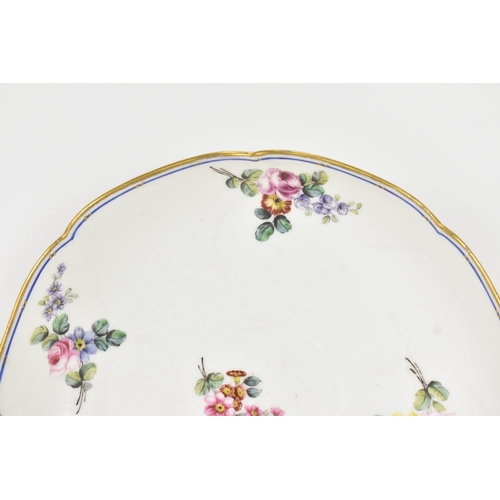 184 - An 18th century Sèvres porcelain lobed dish, painted with finely detailed scattered floral sprays wi... 