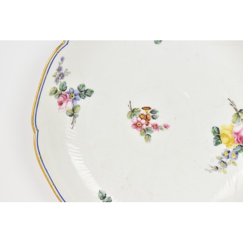 184 - An 18th century Sèvres porcelain lobed dish, painted with finely detailed scattered floral sprays wi... 