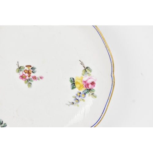 184 - An 18th century Sèvres porcelain lobed dish, painted with finely detailed scattered floral sprays wi... 