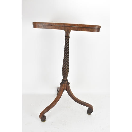 189 - A pair of Regency rosewood lamp tables, the rectangular tops with rounded corners, raised on spiral-... 