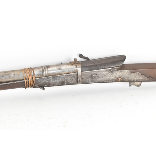 193 - A 19th century Indian toradar matchlock musket, the long steel barrel secured by an iron barrel band... 