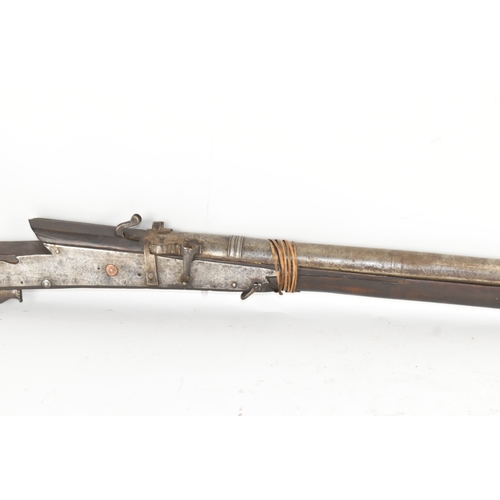193 - A 19th century Indian toradar matchlock musket, the long steel barrel secured by an iron barrel band... 
