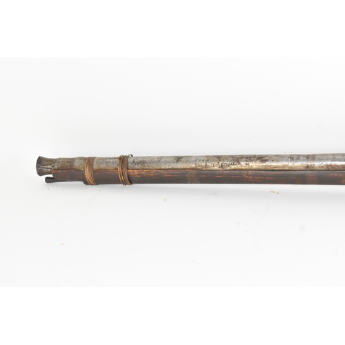 193 - A 19th century Indian toradar matchlock musket, the long steel barrel secured by an iron barrel band... 