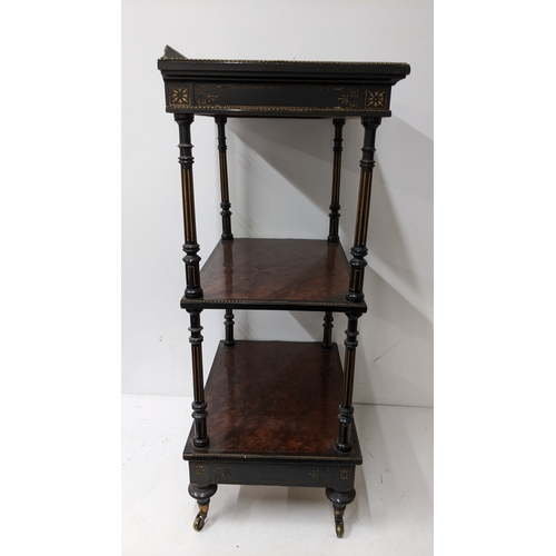 196 - A Gillows Victorian Aesthetic Movement ebonised and amboyna whatnot, the rectangular three-tier top ... 