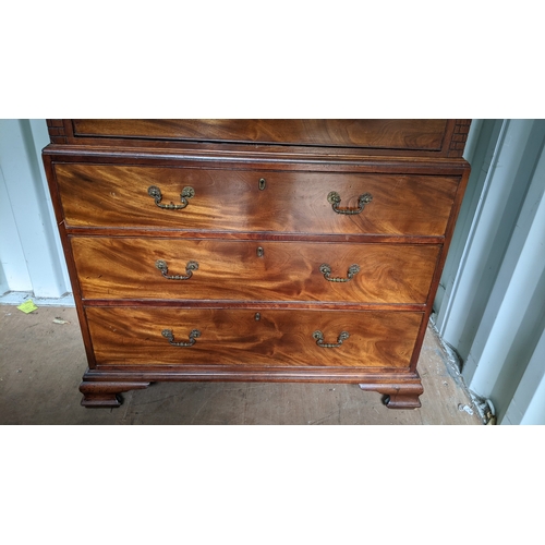203 - A George III mahogany chest on chest, having a dental moulded corner above scroll fretwork, twin ree... 
