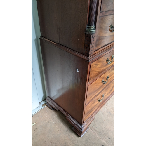 203 - A George III mahogany chest on chest, having a dental moulded corner above scroll fretwork, twin ree... 