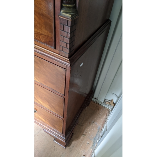 203 - A George III mahogany chest on chest, having a dental moulded corner above scroll fretwork, twin ree... 