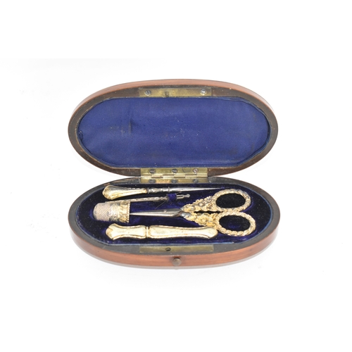 204 - A 19th century gilt metal sewing etui, the scissors cast with floral scroll handles, all housed in a... 