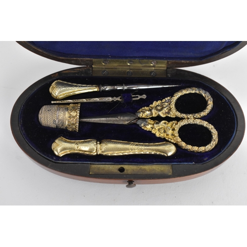204 - A 19th century gilt metal sewing etui, the scissors cast with floral scroll handles, all housed in a... 