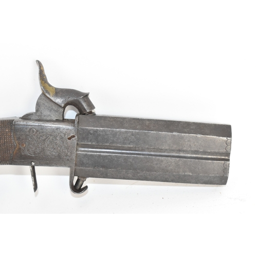 205 - A 19th century English double-barrel pistol, the action engraved with foliate scrollwork and fitted ... 