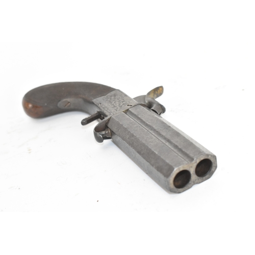 205 - A 19th century English double-barrel pistol, the action engraved with foliate scrollwork and fitted ... 