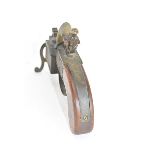 206 - A Dunhill novelty lighter in the form of a flintlock tinderbox, with wooden grips, dummy hammer and ... 