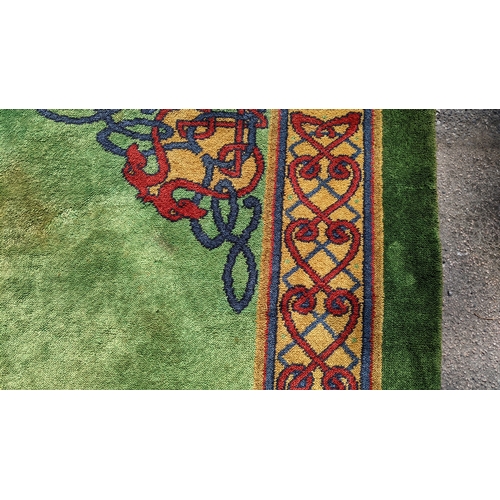 207 - An early 20th century hand-knotted Donegal carpet, the green field centred by a red and blue knotwor... 