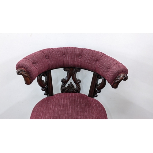 208 - A Victorian mahogany tub chair, with a buttoned curved back and scroll terminals, the pierced splat ... 