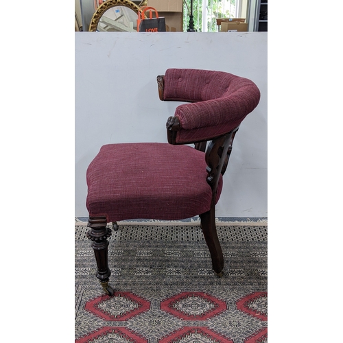 208 - A Victorian mahogany tub chair, with a buttoned curved back and scroll terminals, the pierced splat ... 