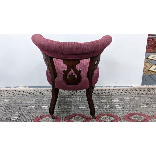 208 - A Victorian mahogany tub chair, with a buttoned curved back and scroll terminals, the pierced splat ... 