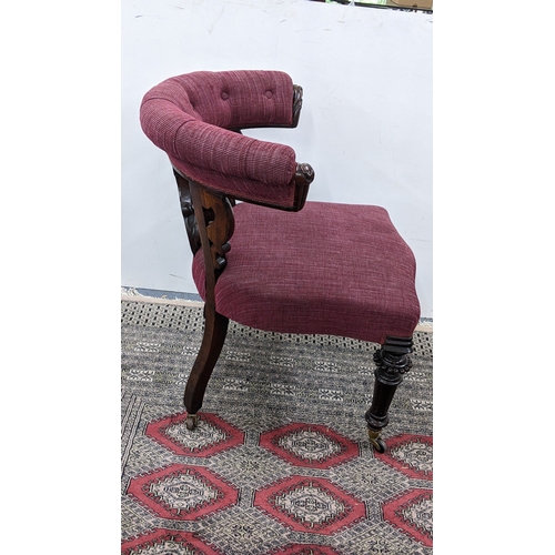 208 - A Victorian mahogany tub chair, with a buttoned curved back and scroll terminals, the pierced splat ... 