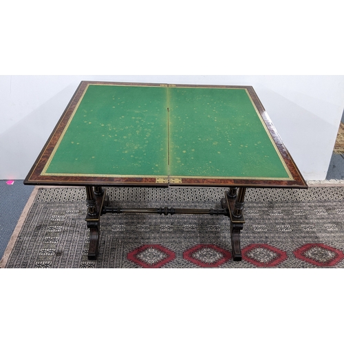 209 - A Gillows Victorian Aesthetic Movement ebonised and amboyna games table, the rectangular hinged top ... 