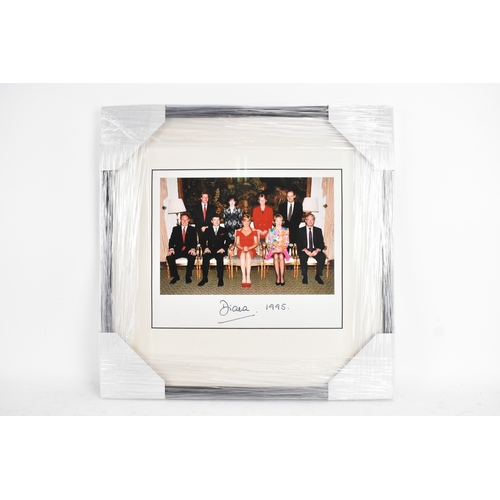 210 - A signed colour group photograph featuring Diana, Princess of Wales seated centrally, with eight oth... 