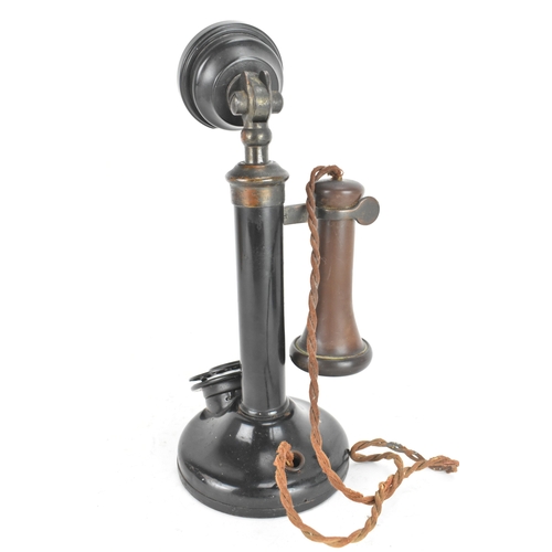 211 - An early 20th century candlestick telephone, model No.150, black lacquered metal and brass, rotary d... 