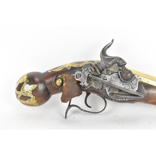 215 - A late 18th/early 19th century Balkan or Ottoman flintlock pistol, with a brass barrel engraved with... 
