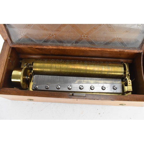 223 - A Victorian rosewood and walnut cased cylinder music box, the hinged rosewood veneered lid with foli... 