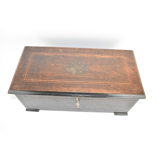 224 - A Victorian ebonized cylinder music box, the rectangular case with line inlay and central motif, enc... 
