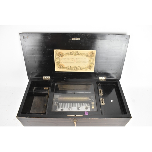 224 - A Victorian ebonized cylinder music box, the rectangular case with line inlay and central motif, enc... 